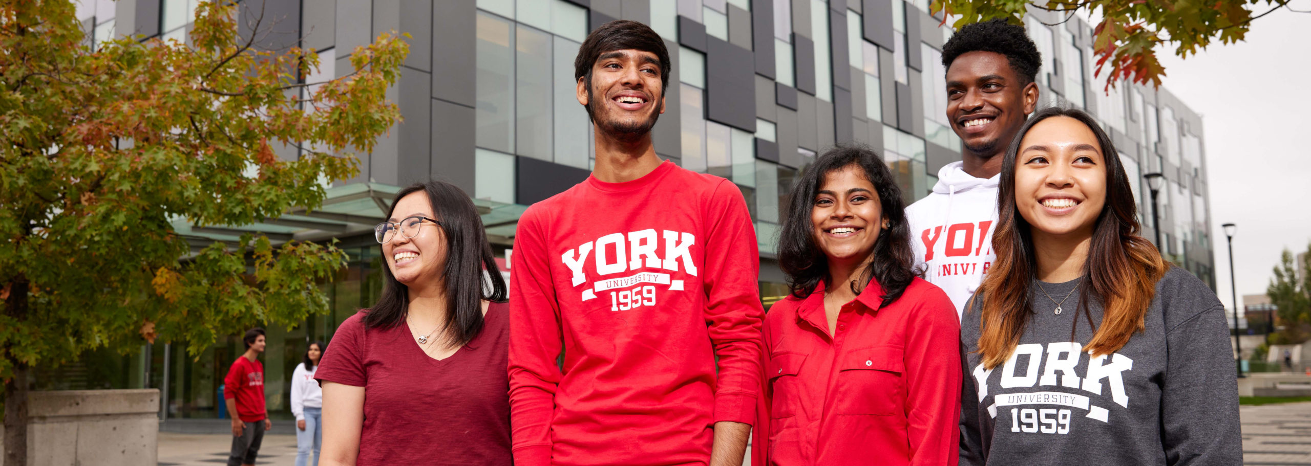 A group of five smiling students wearing York branded clothing.